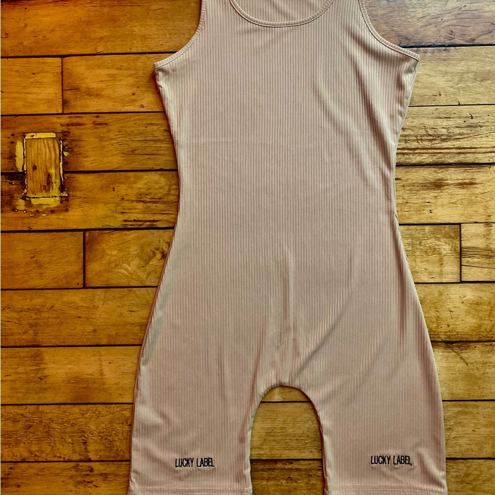 One piece . Tan Romper.. Body suit